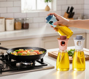 Round transparent glass oil sprayer bottle with colored lid and pump nozzle