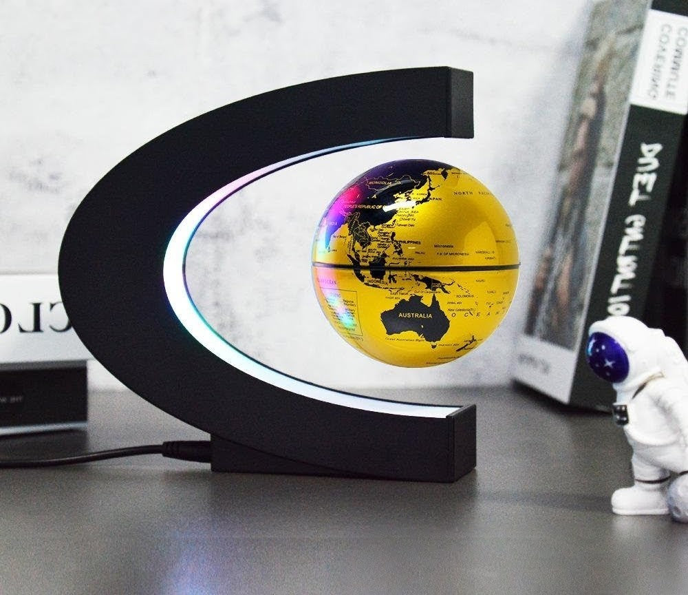Magnetic floating globe with world map, available in gold, black, and blue
