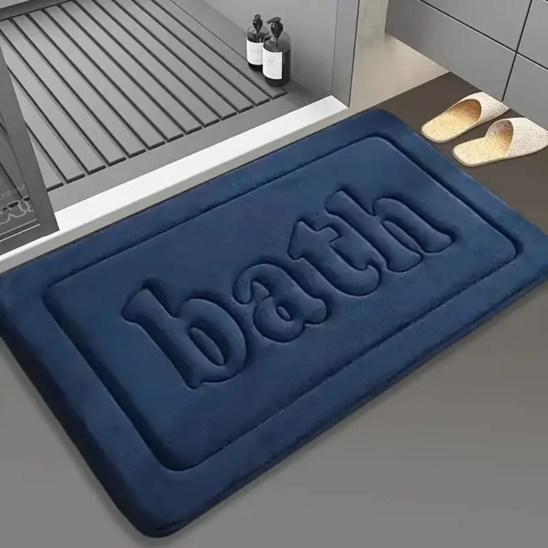 Thickened polyester floor mat with embossed “BATH” lettering, non-slip and absorbent for bathroom or kitchen use