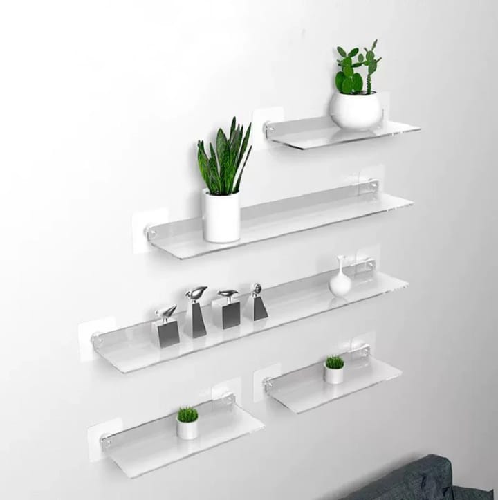 Clear acrylic floating shelf, modern wall-mounted storage for books, décor, or toiletries in small spaces. 