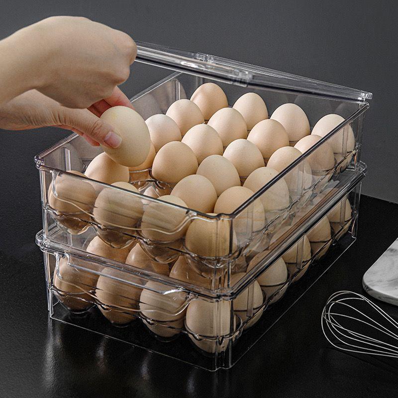 Set of 24 transparent acrylic egg holders for kitchen storage.
