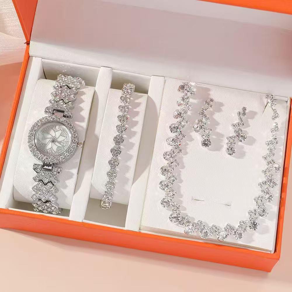 Four piece ladies watch gift set with matching bracelet, necklace, and earrings in gift packaging