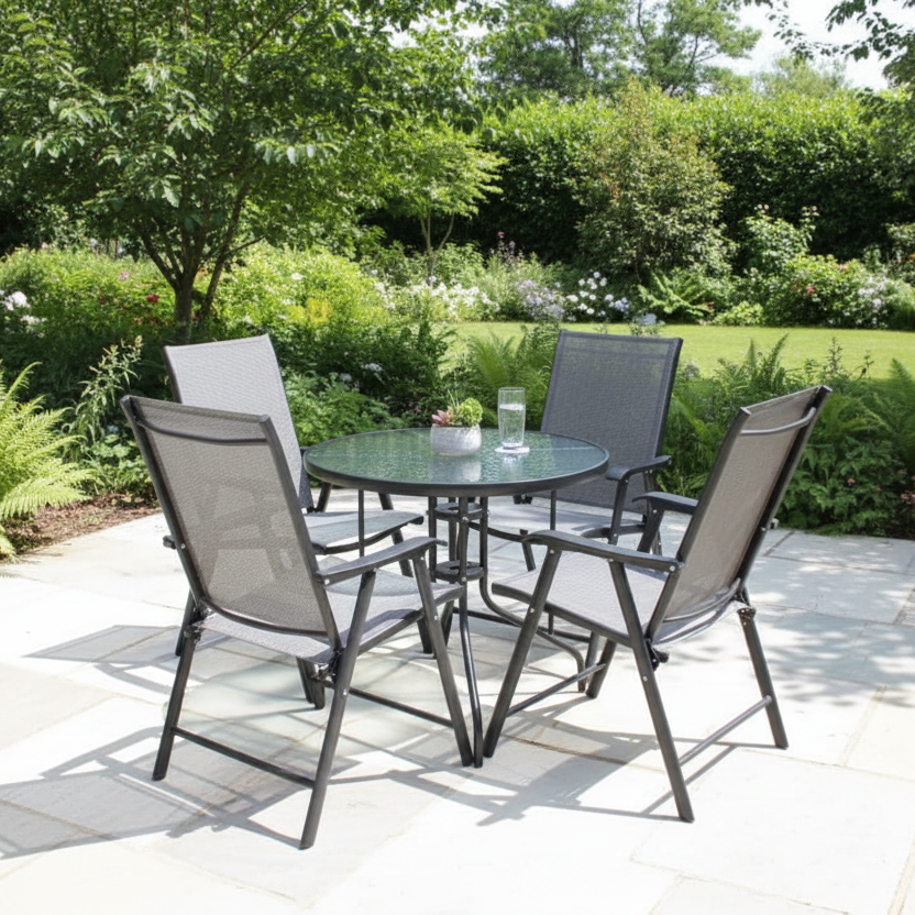 4 piece outdoor patio dining set with round glass table and black folding mesh armchairs for balcony, garden, patio, and outdoor dining spaces.
