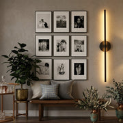 Modern black wireless LED wall sconce with rechargeable design, touch control, and remote operation.