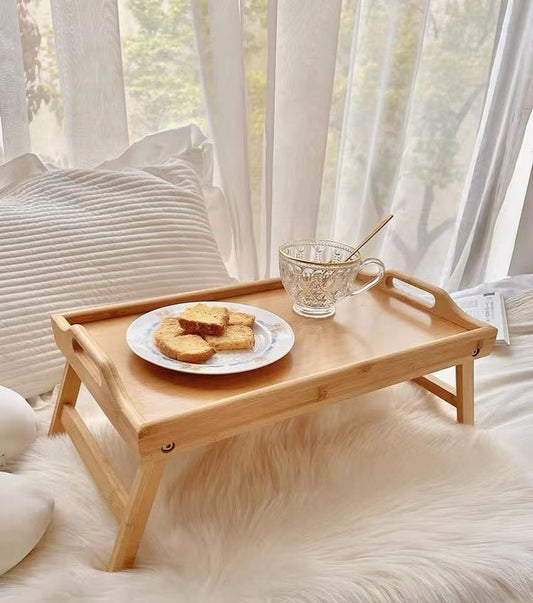 Foldable bamboo tray with folding legs for serving meals, snacks, and working comfortably.
