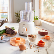 Philips Daily Compact Food Processor HR7310/01 with 700W motor, 2.1L bowl, and multiple food preparation accessories.